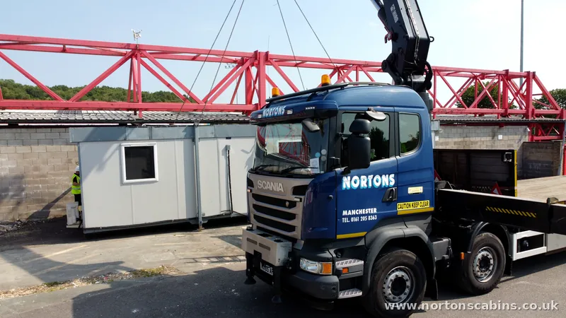 Nortons HIAB lorry delivering a cabin to a North West site