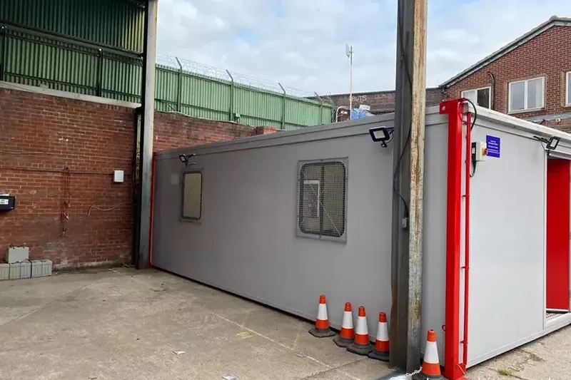 A refurbished portable cabin craned into its final position at a customer site A refurbished portable cabin craned into its final position at a customer site
