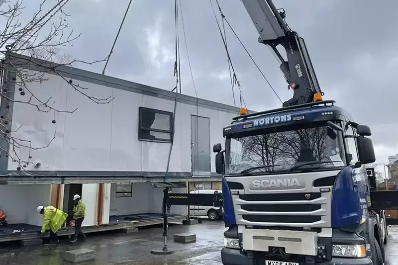 The Nortons crew craning a refurbished unit into position on site