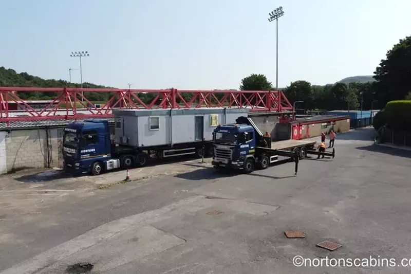 Nortons artic and HIAB positioned on site, ready to lift a cabin into place