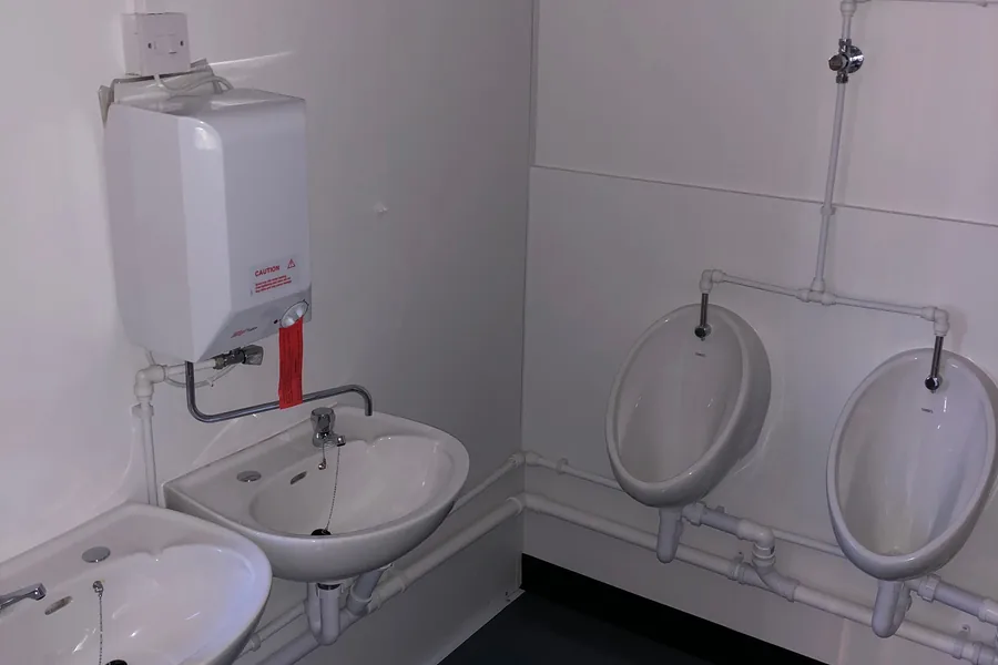 Changing room with wash basin and urinals Changing room with wash basin and urinals