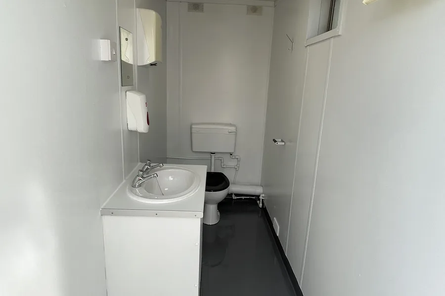 Toilet cabin with wash basin