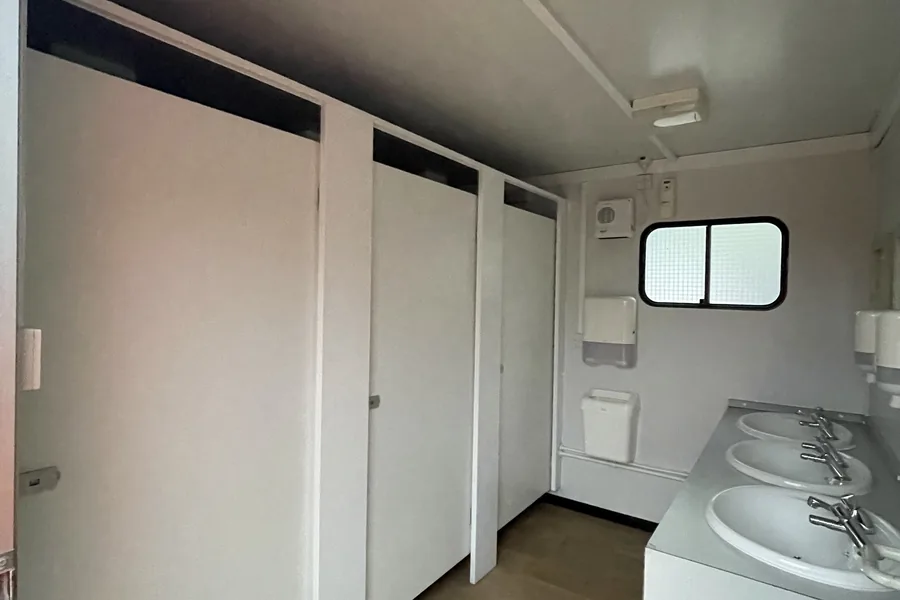 Toilet block with basin and cubicles
