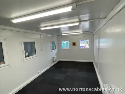 Open-plan portable cabin with carpet