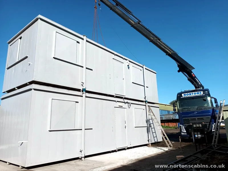 Two-storey modular building lifted into place by HIAB